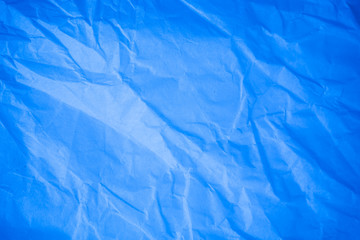 Obraz premium Crumpled blue paper background.
