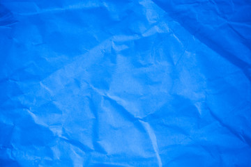 Crumpled blue paper background.