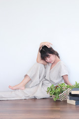 Green nature fruit flower basket and healthy Young  asian woman wearing natural fabric linen minimal clothing - Laying  on the wood floor