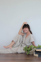 Green nature fruit flower basket and healthy Young  asian woman wearing natural fabric linen minimal clothing - Laying  on the wood floor