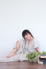 Green nature fruit flower basket and healthy Young  asian woman wearing natural fabric linen minimal clothing - Laying  on the wood floor
