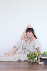 Green nature fruit flower basket and healthy Young  asian woman wearing natural fabric linen minimal clothing - Laying  on the wood floor