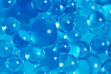 Water blue gel balls. Polymer gel. Silica gel. Balls of blue hydrogel. Crystal liquid ball with reflection. Texture background. Close up macro