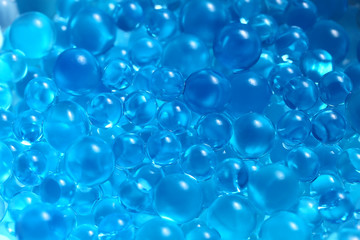 Water blue gel balls. Polymer gel. Silica gel. Balls of blue hydrogel. Crystal liquid ball with reflection. Texture background. Close up macro