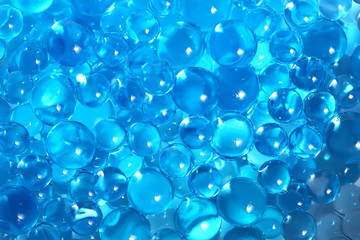 Water blue gel balls. Polymer gel. Silica gel. Balls of blue hydrogel. Crystal liquid ball with reflection. Texture background. Close up macro