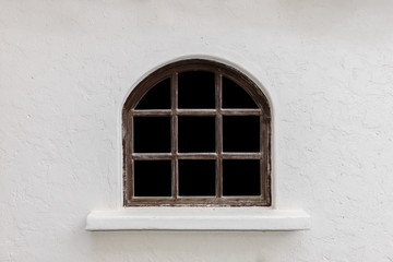 Fototapeta na wymiar Retro style house with antique glass windows on white plaster walls