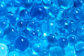 Water blue gel balls. Polymer gel. Silica gel. Balls of blue hydrogel. Crystal liquid ball with reflection. Texture background. Close up macro