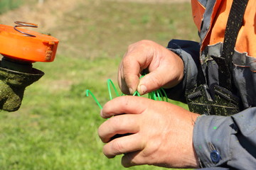 Lawnmower winds a new line for the trimmer in the cassette spool - maintenance of garden tools