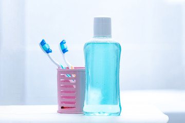 Toothbrushes and mouth rinse in the bathroom for oral hygiene, health of teeth and gums. Fresh breath. Teeth care.