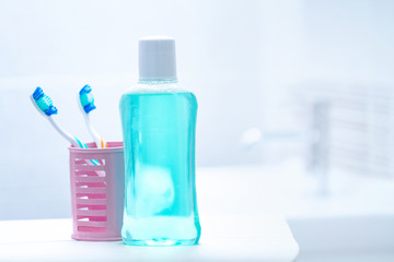 Toothbrushes and mouth rinse in the bathroom for oral hygiene, health of teeth and gums. Fresh breath. Teeth care.