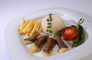 rolled beef steaks filled with cheese with salad and french fries