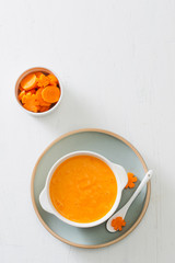 Carrot baby puree in bowl isolated on light background