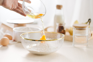 fresh eggs milk and flour on white table