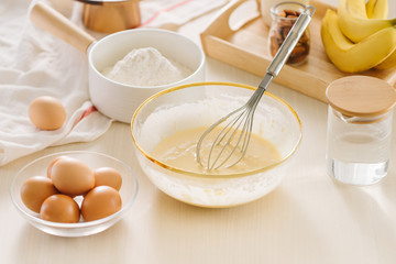 Ingredients and tools for baking sweet cake with banana and almonds