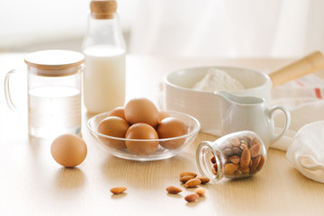 Ingredients and tools for baking sweet cake with banana and almonds