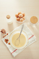 recipe ingredients : eggs, flour, milk, almonds, banana on white background