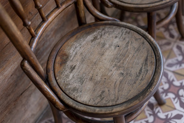 Old wooden chair, background, printed pattern tiles 