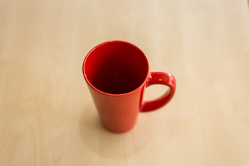 Red coffee cup on a wooden table