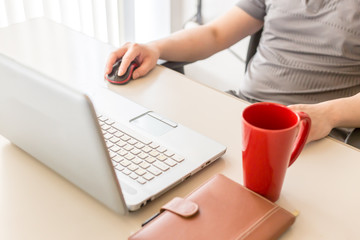 Young man working with laptop Notebook and coffee cup On the office desk 