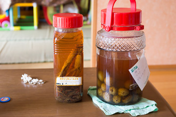 Chiba, Japan, 05/04/2019 , homemade alcoholic beverages made with japanese plums, and ginseng, 20 years of age
