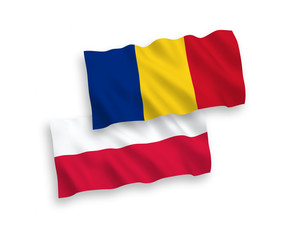 National vector fabric wave flags of Romania and Poland isolated on white background. 1 to 2 proportion.