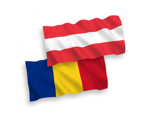National vector fabric wave flags of Austria and Romania isolated on white background. 1 to 2 proportion.