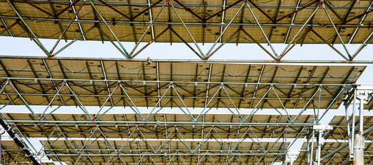Looking up at the bottom of the solar photovoltaic panel with automatic rotating bearings
