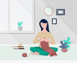 Young woman knitting in modern living room.