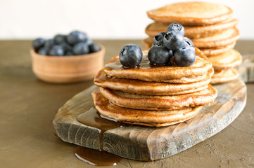 Chocolate pancakes with blueberries on a dark background.