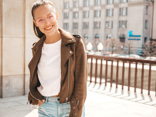 Portrait of beautiful smiling brunette model dressed in summer hipster jacket clothes. Trendy girl...
