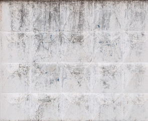 Fragment of a concrete fence. Peeling concrete fence. Peeling concrete wall. Background.