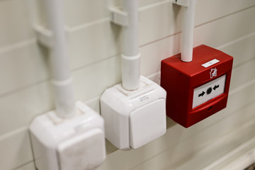Wall white plastic power button on the wall and safety fire button.