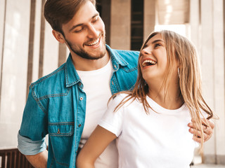 Portrait of smiling beautiful girl and her handsome boyfriend. Woman in casual summer jeans clothes. Happy cheerful family. Female having fun and looking at each other