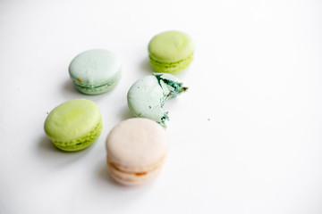 Assorted macaroons in craft paper box flat lay.white table background. top view Copyspace horizontal