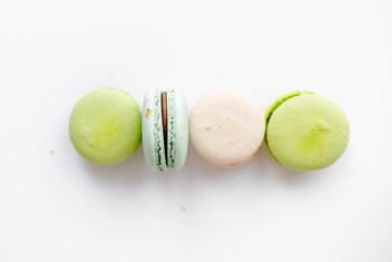 Assorted macaroons in craft paper box flat lay.white table background. top view Copyspace horizontal