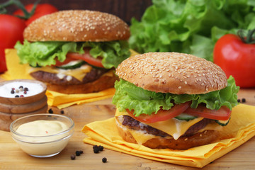 Two fresh hamburgers with vegetables