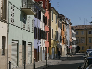 Fototapeta na wymiar Colored houses in Parma. Colored houses along the street Borgo del Correggio in the historic center of Parma.
