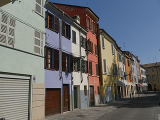 Fototapeta na wymiar Colored houses in Parma. Colored houses along the street Borgo del Correggio in the historic center of Parma.