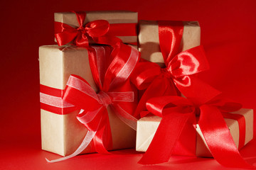 Gifts packed with craft paper and colorful satin ribbons	
