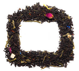Frame of dry black tea with flowers, isolated on white