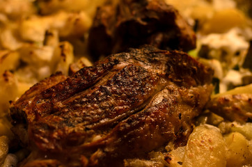 Closeup shot of  turkey meat with potato baked in oven, horizontal, rustic style. Thanksgiving dinner