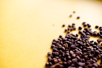 Roasted coffee grains and takeaway cup top view. Craft paper tea cup on orange background flat lay. Cafe web banner with copyspace