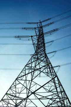 Electricity pole against blue sky clouds in dawn time, Transmission line of electricity to rural, electricity transmission pylon