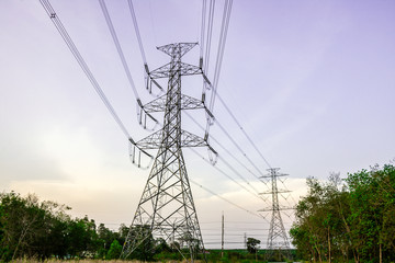 Electricity pole with silhouette sunset sky, Electricity pylon with shadow of tree in dawn time, Electricity power transmission line on sunset with copy space, Electricity pylon on orange sky