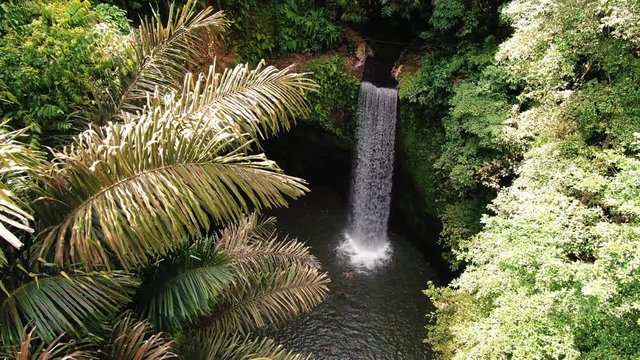 Tibumana waterfall Bali Indonesia film from drone