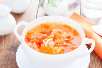 vegetable soup with onions and cabbage for onion diets in a white bowl, horizontal