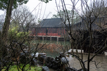Historical building with wooden red and white wall in China park in Suzhou city