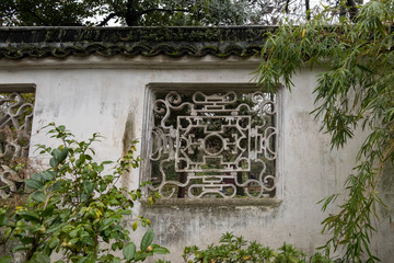 China, Suzhou, Humble Government Park garden wall with decorative window
