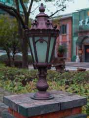 Ancient Gas lamp staying on brick fence in the Shanghai city