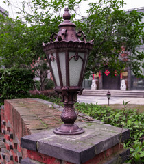 Ancient Gas lamp staying on brick fence in the Shanghai city